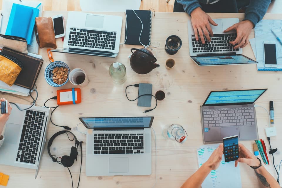 Phones and laptops on a shared table