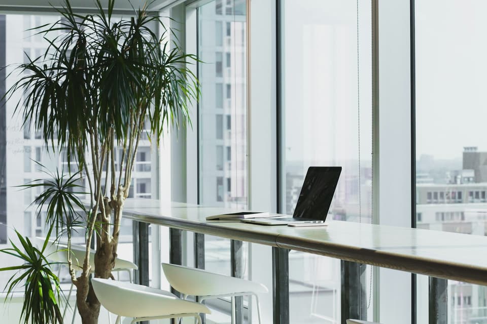 Office workspace by a large window